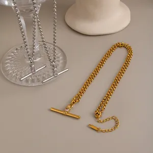 Detail view of T-bar pendant necklace with zircon inlay in gold and silver finish