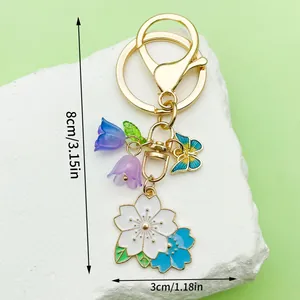 Detailed view of a floral cherry blossom keychain with 8cm and 3cm size markings