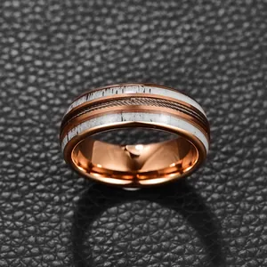 Close-up of 8mm rose gold tungsten ring with antler inlay and steel wire detail