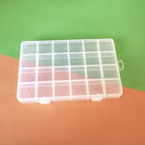 Close-up of a 24-grid transparent plastic storage box for DIY jewelry beads.