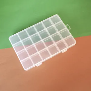 Detailed view of the 24-grid clear plastic storage box for DIY bead organizing