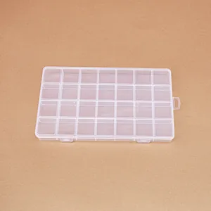 Top-down view of a clear 28-compartment plastic storage box for beads and jewelry