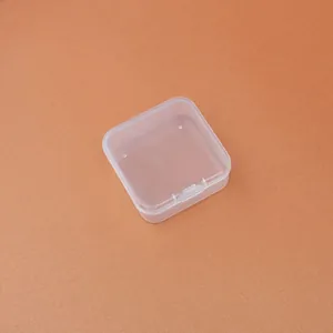 Close-up detail of a small transparent square PP plastic storage box with a hinged lid