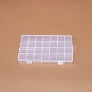 Top view of a 28-compartment transparent plastic storage box with fixed dividers.