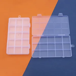 Detailed close-up showing the 15-compartment clear plastic storage box with fixed dividers