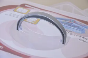 Detail of the ergonomic grey handle on a transparent 3-layer plastic storage box