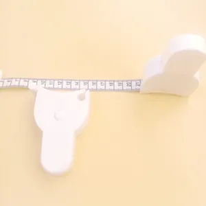 Detailed view of a white Y-shaped body tape measure for waist and hip measurement