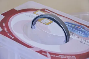 Detail of the sturdy grey handle on a 3-tier clear plastic storage box for crafts.