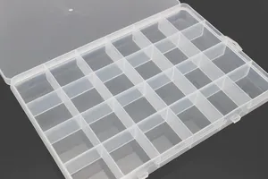 Detailed close-up of 24 fixed grids in a clear plastic storage box for small jewelry