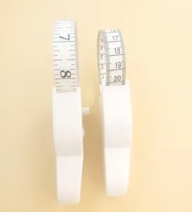 Detail of dual-scale white Y-shaped waist measuring tape for body measurements