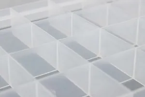 Close-up detail of the 24 fixed compartments in the transparent plastic storage box