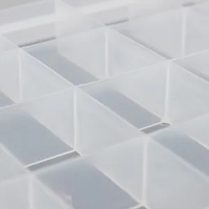 Close-up of 24-grid fixed clear plastic organizer box for jewelry and beads storage