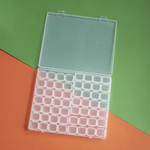 Macro view of 56-grid transparent plastic storage organizer for diamond painting beads