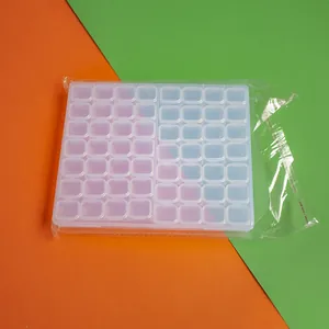 Macro view of a 56-grid transparent plastic storage box for jewelry and beads organizer.