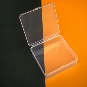 Close-up detail of a clear square plastic storage box with open hinged lid design