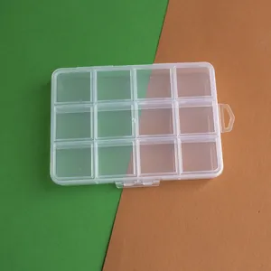 Detailed view of a 12-compartment clear plastic storage box for jewelry beads