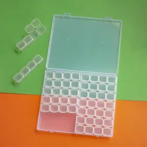 Detailed view of the 56-grid transparent plastic storage box showing removable small cases