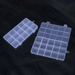 Detail of 15-compartment transparent plastic storage box with double buckle latches.