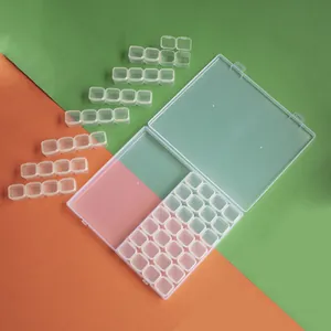Detailed view of a 56-grid transparent plastic storage box for diamond painting accessories