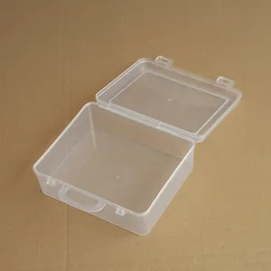 Detailed view of a small transparent plastic storage box featuring a lid and carry handle