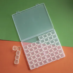 Detail view of 56-grid clear plastic storage box showing removable individual compartments.