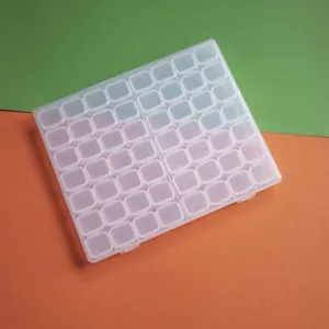 Detailed macro view of a 56-grid clear plastic storage box for diamond painting beads and jewels