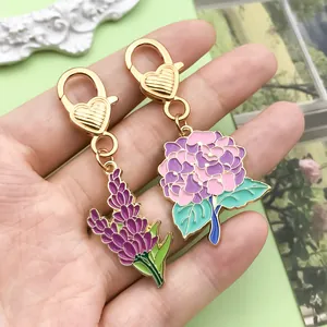 Detail showing colorful enamel hydrangea and lavender pendants on gold-tone keychains