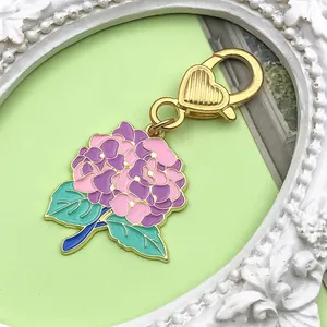 Close-up of a colorful enamel hydrangea flower charm for keychains or accessory bags.