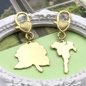 Macro detail of golden flower charms showing radiant texture and heart lobster clasps