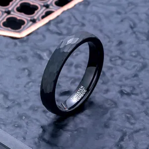 Macro view of black hammered tungsten carbide ring showing unique faceted texture