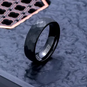 Close-up of black hammered tungsten carbide ring showing fine texture and inner engraving