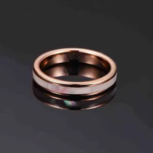 Detail view of 4mm rose gold tungsten ring with white mother of pearl inlay