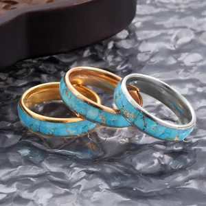 Detailed view of 6mm tungsten steel rings with blue turquoise inlay and gold veins