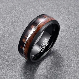 Macro detail of 8mm black tungsten ring with acacia wood inlay and silver arrow