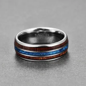 Close-up macro detail of 8mm tungsten ring with acacia wood and blue meteorite inlay.