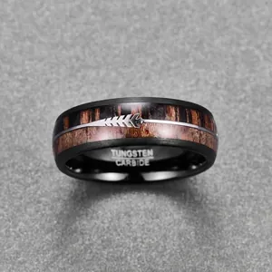 Detail of 8mm black tungsten ring with acacia wood inlay and silver arrow design.