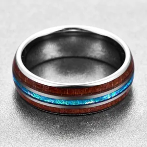 Detailed close-up of 8mm tungsten steel ring featuring acacia wood and blue opal inlay.