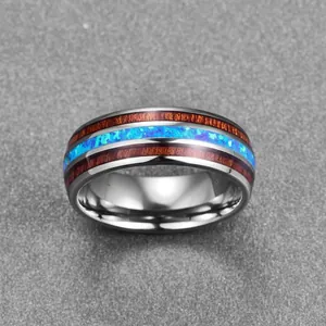 Detailed close-up of 8mm dome tungsten steel ring with acacia wood and blue opal