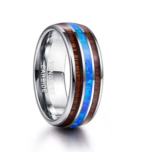 Detailed view of the 8mm wide tungsten steel ring with acacia wood and blue opal inlays
