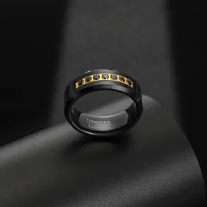 Detail shot of 8mm black tungsten carbide men's ring with gold inlay and black cubic zirconia