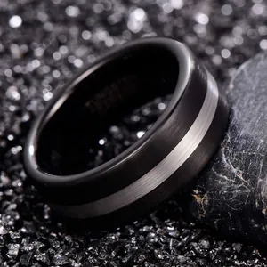 Macro detail of 8mm brushed black and silver tungsten carbide ring for men's jewelry