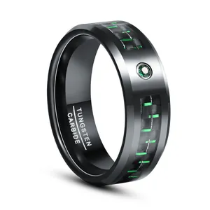 Detail of 8mm black tungsten carbide ring with green carbon fiber inlay and zircon stone.