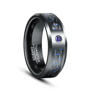 Macro view of a black 8mm tungsten carbide ring with blue zircon and carbon fiber inlay