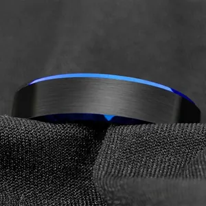 Macro detail of 6mm black matte tungsten steel ring with a vibrant blue beveled edge