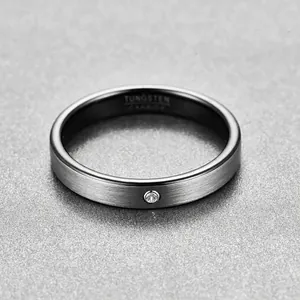 Close-up of a 4mm brushed tungsten steel ring with black inner plating and tiny diamond