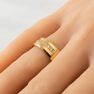 Close-up of 8mm gold-plated tungsten steel ring with cubic zirconia inlay on finger.