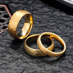 Close-up of gold hammered tungsten carbide rings in 4mm, 6mm, and 8mm widths.