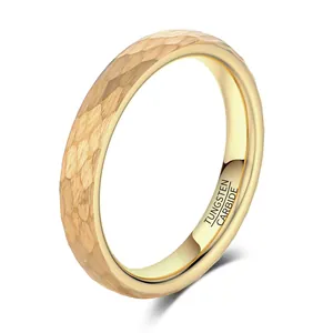 Close-up of gold-plated hammered tungsten carbide ring with engraved material mark.