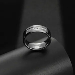 Close-up of 8mm men's tungsten carbide ring with zircon inlay and internal engraving.