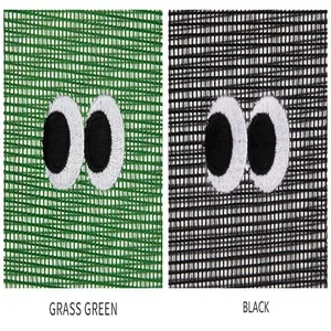Close-up detail of mesh storage bags in grass green and black with cute eye embroidery